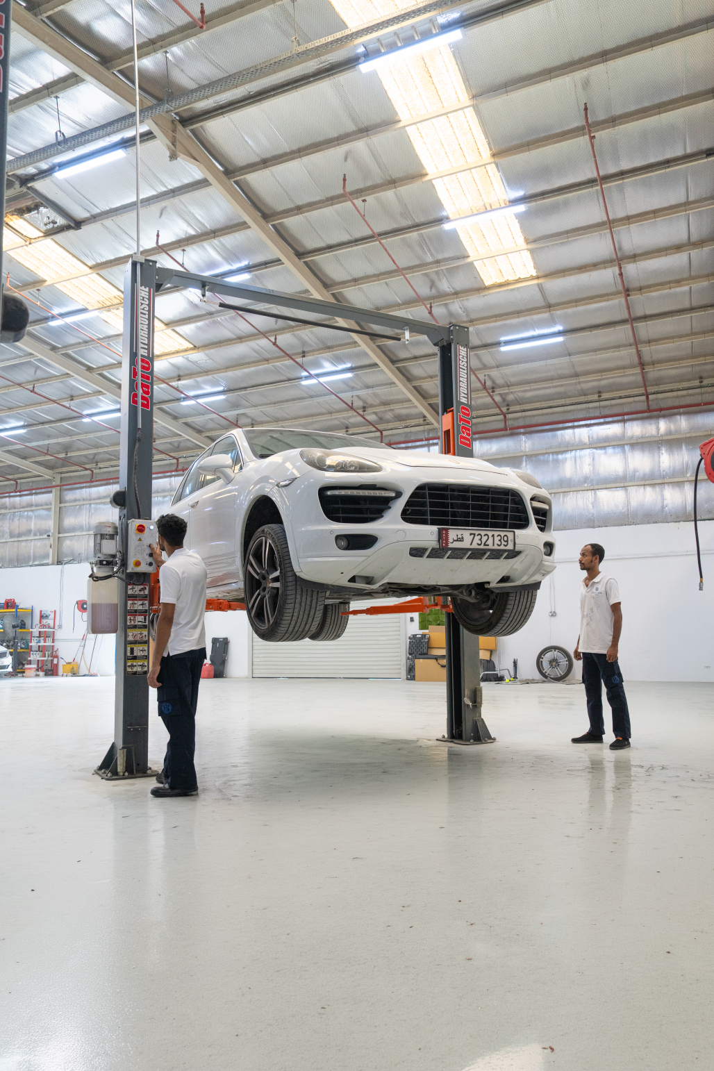 Forbass Motors team member inside the Doha workshop